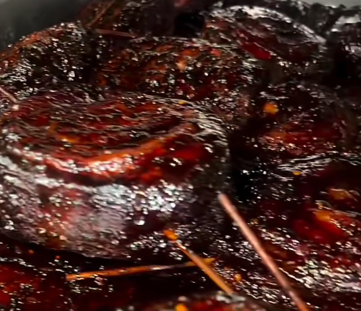 Pinwheels 1 Close-up of glossy, charred barbecue ribs with a dark caramelized glaze.